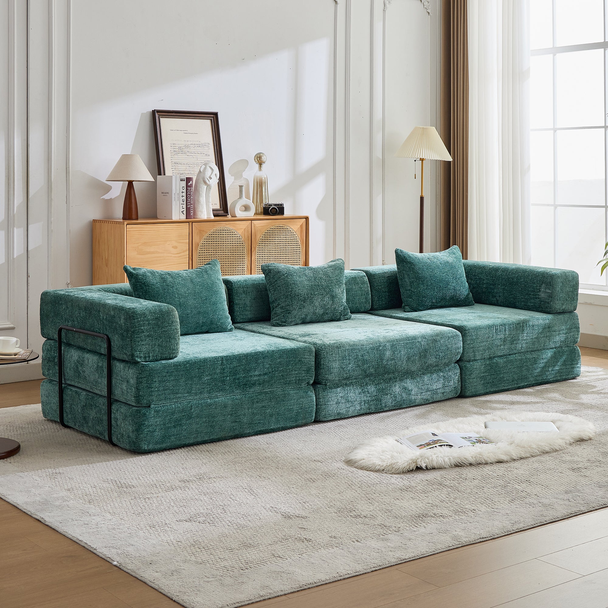 Sofá modular de chenil verde petróleo en un salón luminoso
